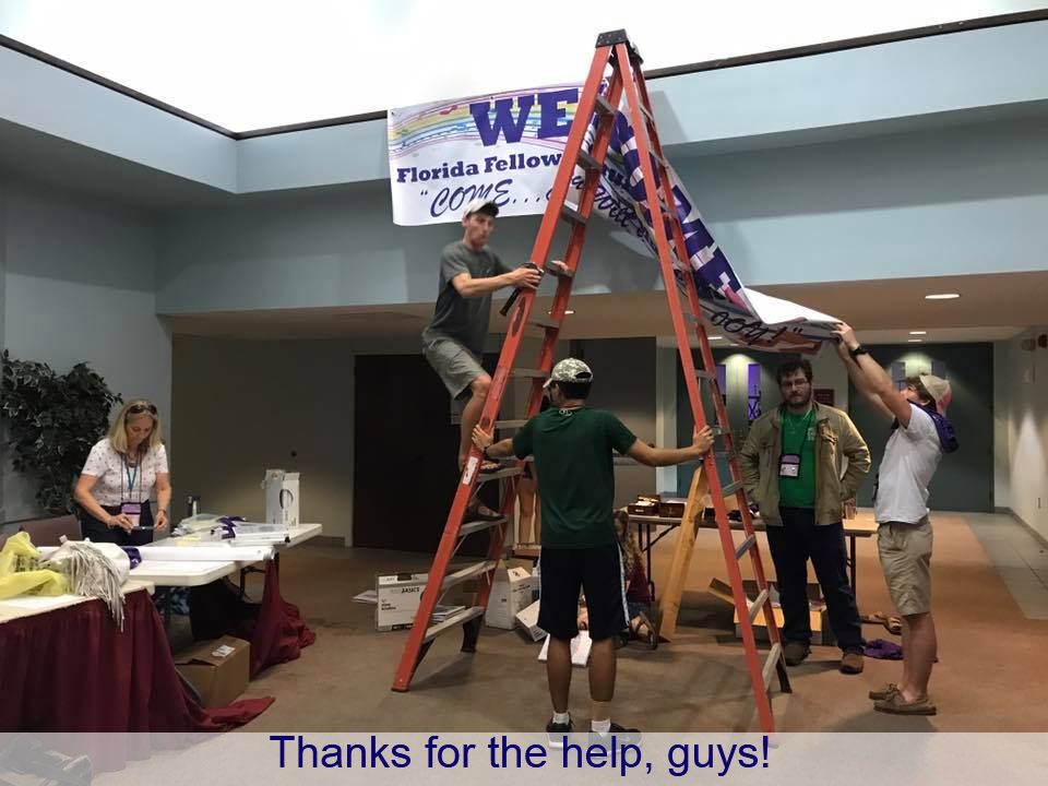 Putting up the Welcome Banner for the 2017 Florida FUMMWA Summer Workshop